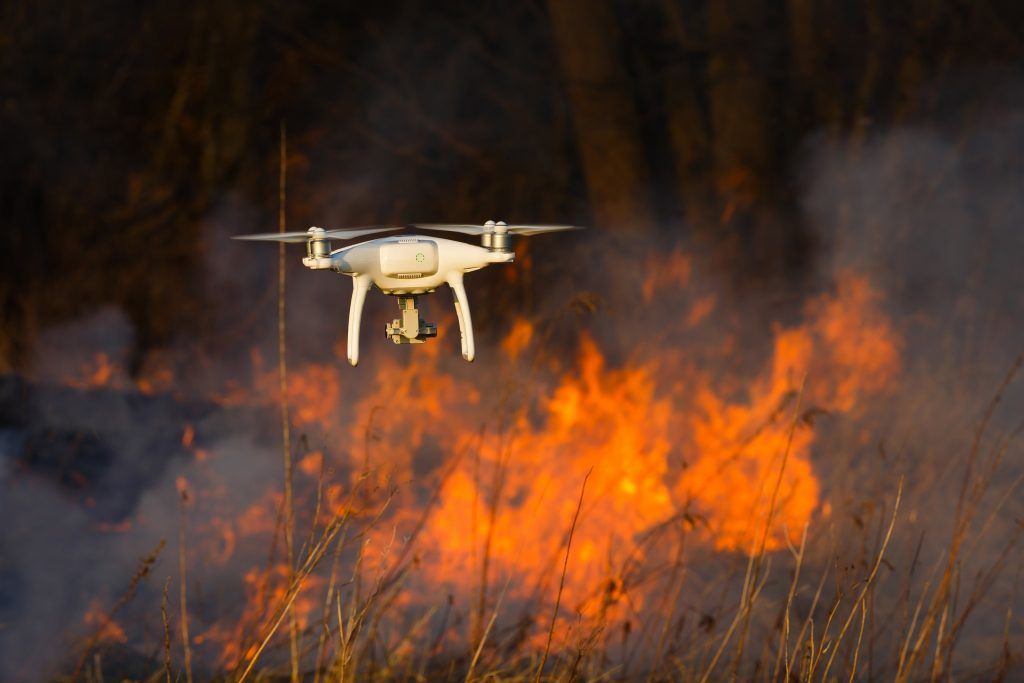 Drone flying up to a fire